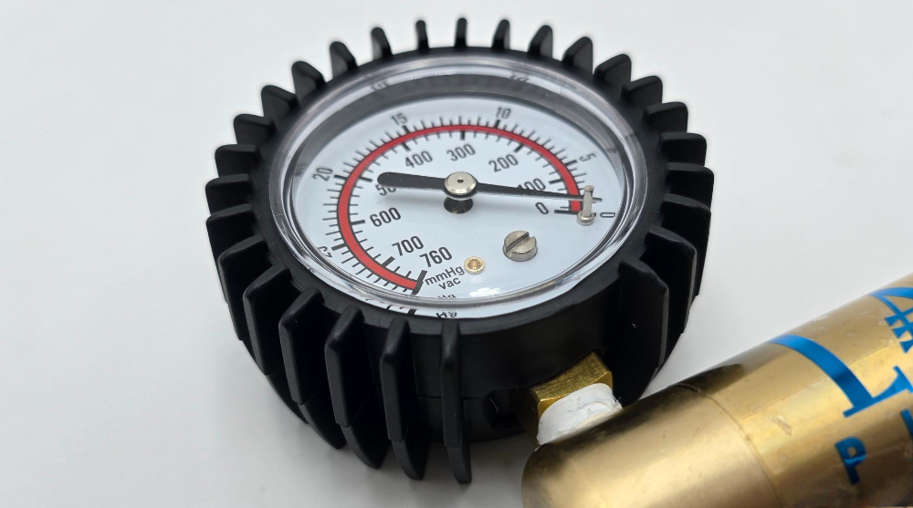 LA Pump rubber gauge protection cover fitted around a brass pump gauge
